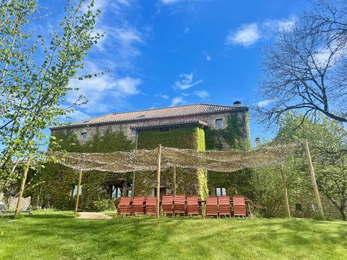 a group of chairs in front of a building at L'ancien Relais de Poste*** in Saint-Dier-dʼAuvergne