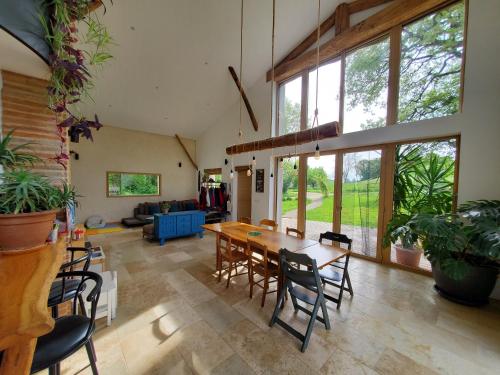 a large living room with a wooden table and chairs at Au Moulin du Miech in Salvagnac
