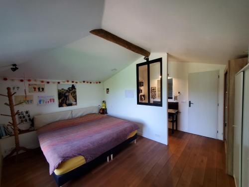 a bedroom with a large bed and a desk at Au Moulin du Miech in Salvagnac