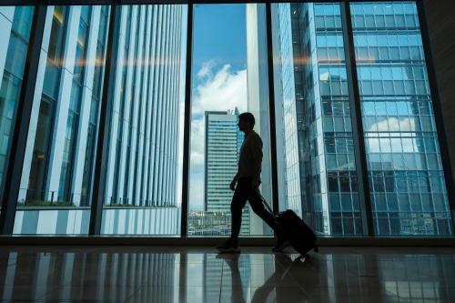 a man walking with a suitcase in a building at Nagoya JR Gate Tower Hotel in Nagoya
