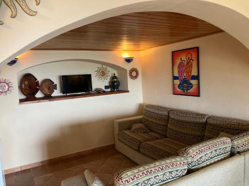 a living room with a couch and a tv at appartamento in Pantelleria