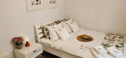 a bedroom with a bed with a hat on it at Willa Joanna in Gdańsk