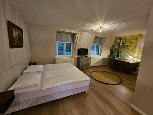 a bedroom with a large bed and a bathroom at De Arcense Herberg in Arcen