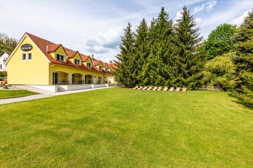 a large yard in front of a house at Penzion Kormorán in Vranov nad Dyjí