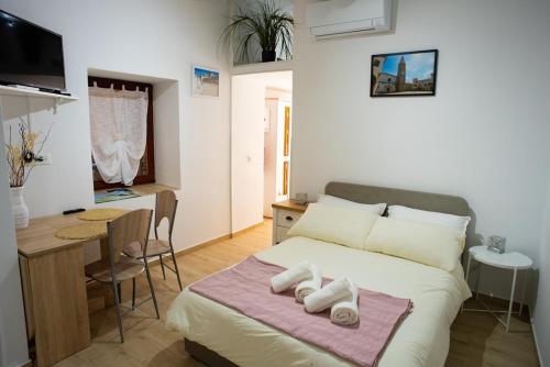 ein Schlafzimmer mit einem Bett mit zwei Handtüchern darauf in der Unterkunft Studio GabAmi in Koper