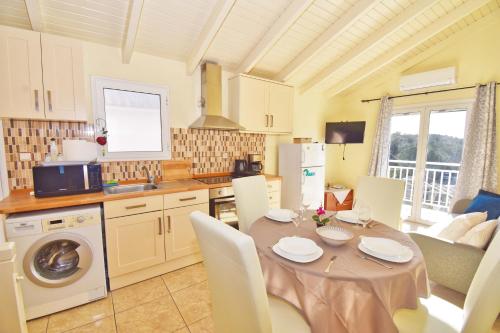 a kitchen with a table with chairs and a dining room at Nikolas Beach House in Mesongi