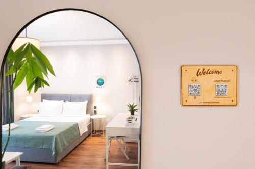 a bedroom with a bed and a table and a mirror at Escape Stay Center Xanthi - Private Parking - MenoHomes 4A in Xanthi