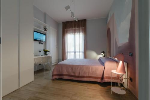 a bedroom with a bed and a desk and a television at B&B La Perla in Frosinone