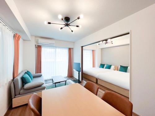 a room with a bedroom with a bed and a mirror at aLATO Kinshicho in Tokyo