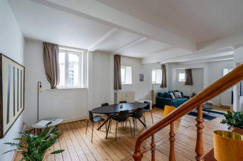 a living room with a table and chairs at Smartflats - Theatre Antwerp in Antwerp