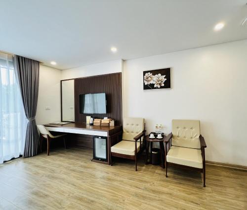 um quarto com uma secretária, cadeiras e uma mesa em Catba View Hotel em Ilha de Cát Bà
