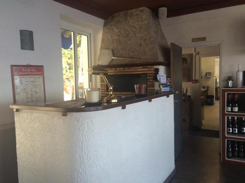 a kitchen with a white counter top and a window at Bel Mare in Cargèse