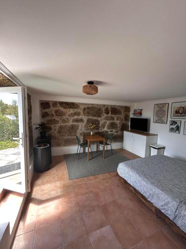 a bedroom with a bed and a table at Zevari studio with amazing views! in Folhadosa