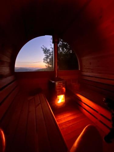 a room with a window with a view of the sunset at Zevari studio with amazing views! in Folhadosa
