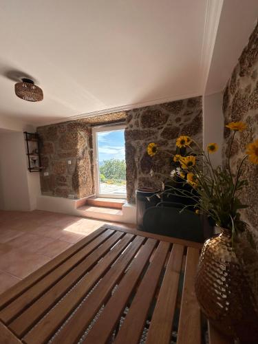 a room with a wooden bench and a window at Zevari studio with amazing views! in Folhadosa