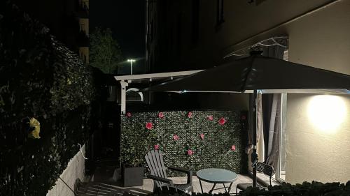 a patio with a table and chairs and an umbrella at Adam Eric in La Spezia