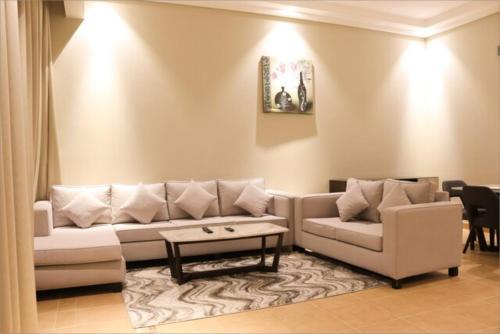 a living room with a couch and a coffee table at Infinity Tower Suites WLL in Manama