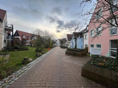 a cobblestone street in a residential neighborhood with houses at EG Ferienwohnung 4 Personen 1 in Rieden