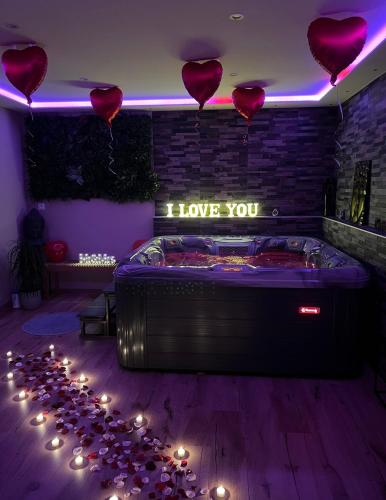 a room with a bed with hearts on the wall at Zen&spa appartement avec jacuzzi et sauna privatif in Aspach-le-Bas