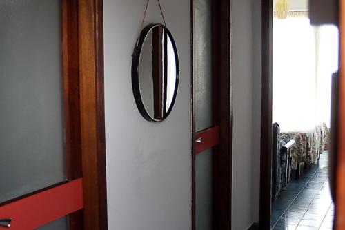 a mirror hanging on a wall next to a door at Hotel Piccolo Paradiso in Bordighera