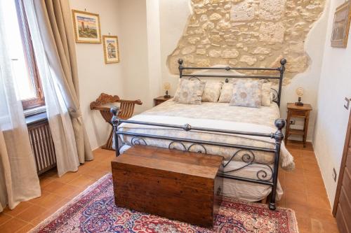 a bedroom with a bed with a wooden table at LA TORRE DELLA RIPA in Tarquinia