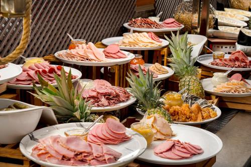 a buffet with plates of food on a table at Kaya Palazzo Golf Resort in Belek