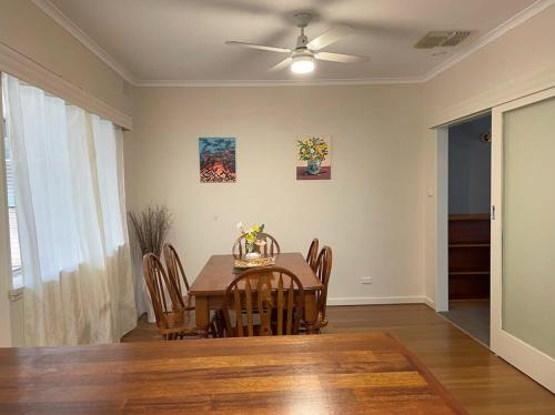 a dining room table with chairs and a ceiling fan at The Hidden Gem Exquisite 3BR Retreat in Berri in Berri