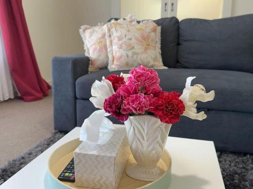 a vase with flowers on a table in a living room at The Hidden Gem Exquisite 3BR Retreat in Berri in Berri