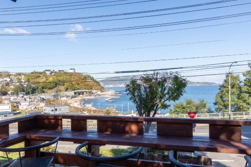 a balcony with a bench and a view of the water at Populus-club Otaru - Vacation STAY 91869v in Otaru