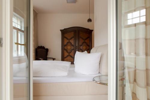 a bed with white pillows sitting on a window sill at Villa Elbufer in Bad Schandau
