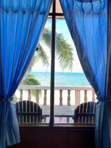 a view of the ocean from a room with a window at Rainbow Bungalow Haadrin Koh Phangan in Haad Rin