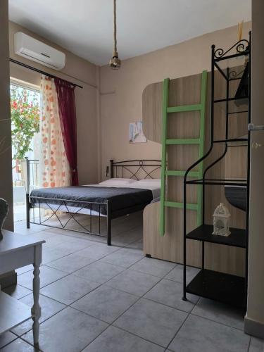 a bedroom with two beds and a green ladder at Mary's house in Kyparíssion