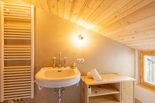 baño con lavabo y techo de madera en Haus Victoria, en Schruns