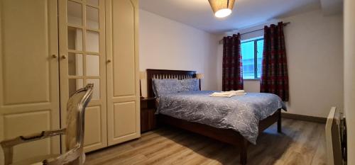 a small bedroom with a bed and a window at Liffey Suite in Dublin