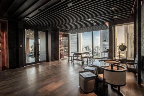 a living room with a view of a city at The Clan Hotel Singapore by Far East Hospitality in Singapore