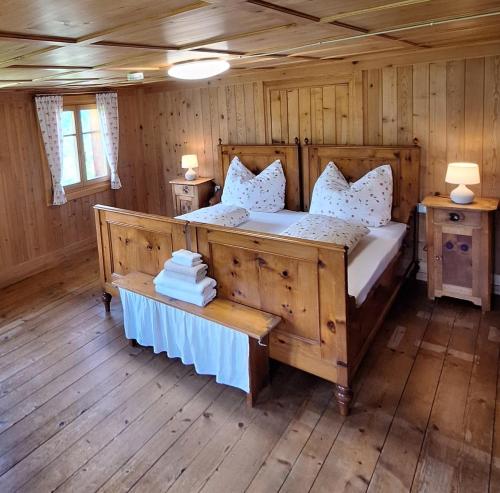 a bedroom with a large bed in a cabin at Zom Ruaba in Bartholomäberg