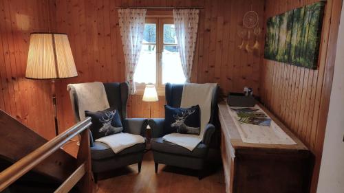 a room with two chairs and a table and a window at Zom Ruaba in Bartholomäberg