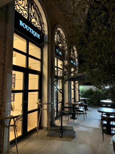 a store front with tables and chairs in a building at Cosmopolita Boutique Hotel in Timişoara
