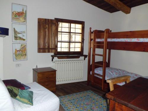 a bedroom with a bed and a bunk bed at Baita del Plan in Pragelato