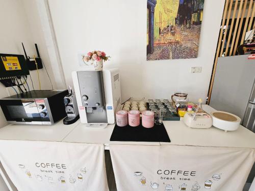 a table with a coffee machine and cups on it at STAYHERE@AIRPORT SERVICE APARTMENT in Ban Bo Han