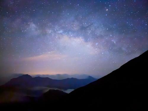 a starry night with the milky way over the mountains at Water Swing B&B in Renai