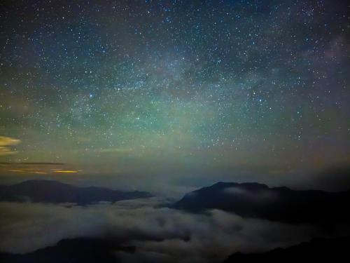 a starry night with the milky way above the clouds at Water Swing B&B in Renai