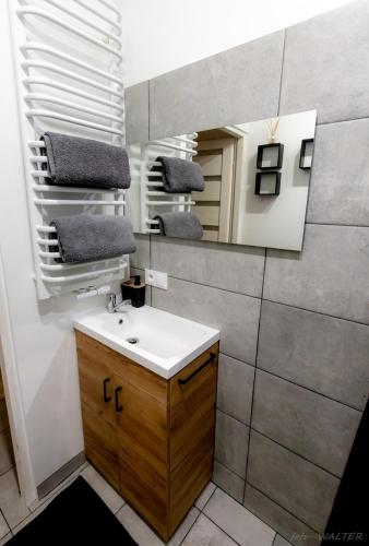 a bathroom with a sink and a mirror at KLIF 2 Warka in Warka