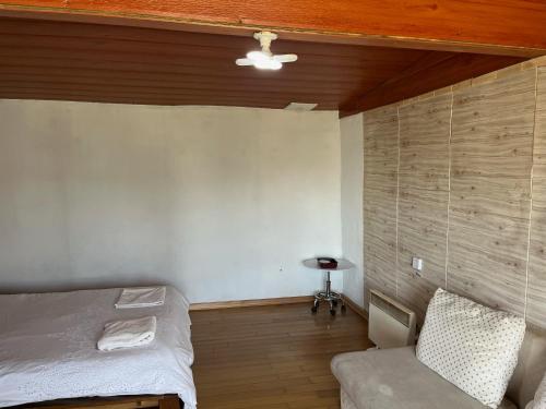 a small room with a bed and a chair at Gana's Guest House and Tours in Ulaanbaatar