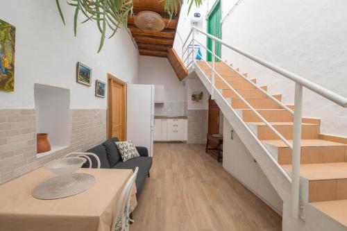 a living room with a staircase and a couch at Agaete Botanic - Rooftop Solarium in Agaete