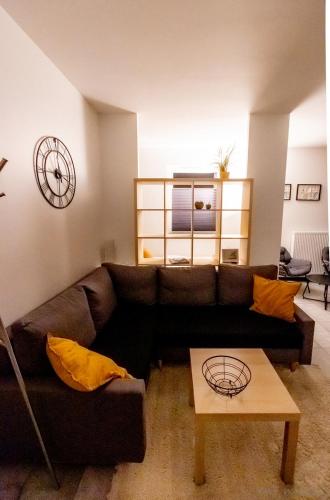 a living room with a brown couch and a table at KLIF 2 Warka in Warka