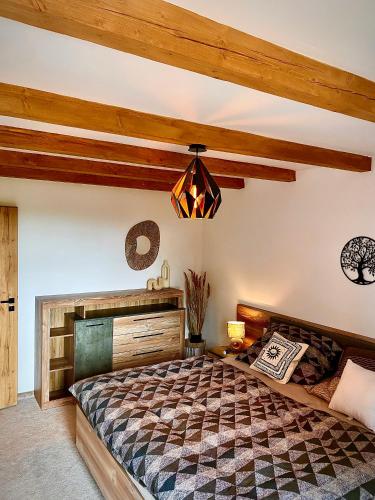 a bedroom with a bed and a chandelier at Dream House - Vysoké Tatry in Vysoké Tatry