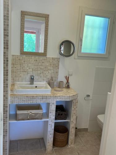 a bathroom with a sink and a mirror at La Belle Rivière in Salernes