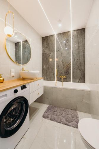 a bathroom with a washing machine and a sink at 3 Bedrooms Premium Bella Blue for 6 Guests with AC and Free out side Parking in Rzeszów
