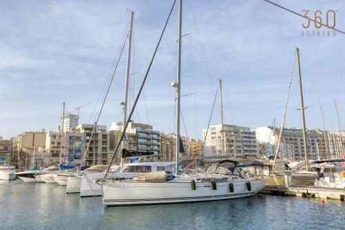 a group of boats are docked in a marina at Lovely designer 3BR Apt with Private Terrace with BBQ by 360 Estates in Tal-Pietà